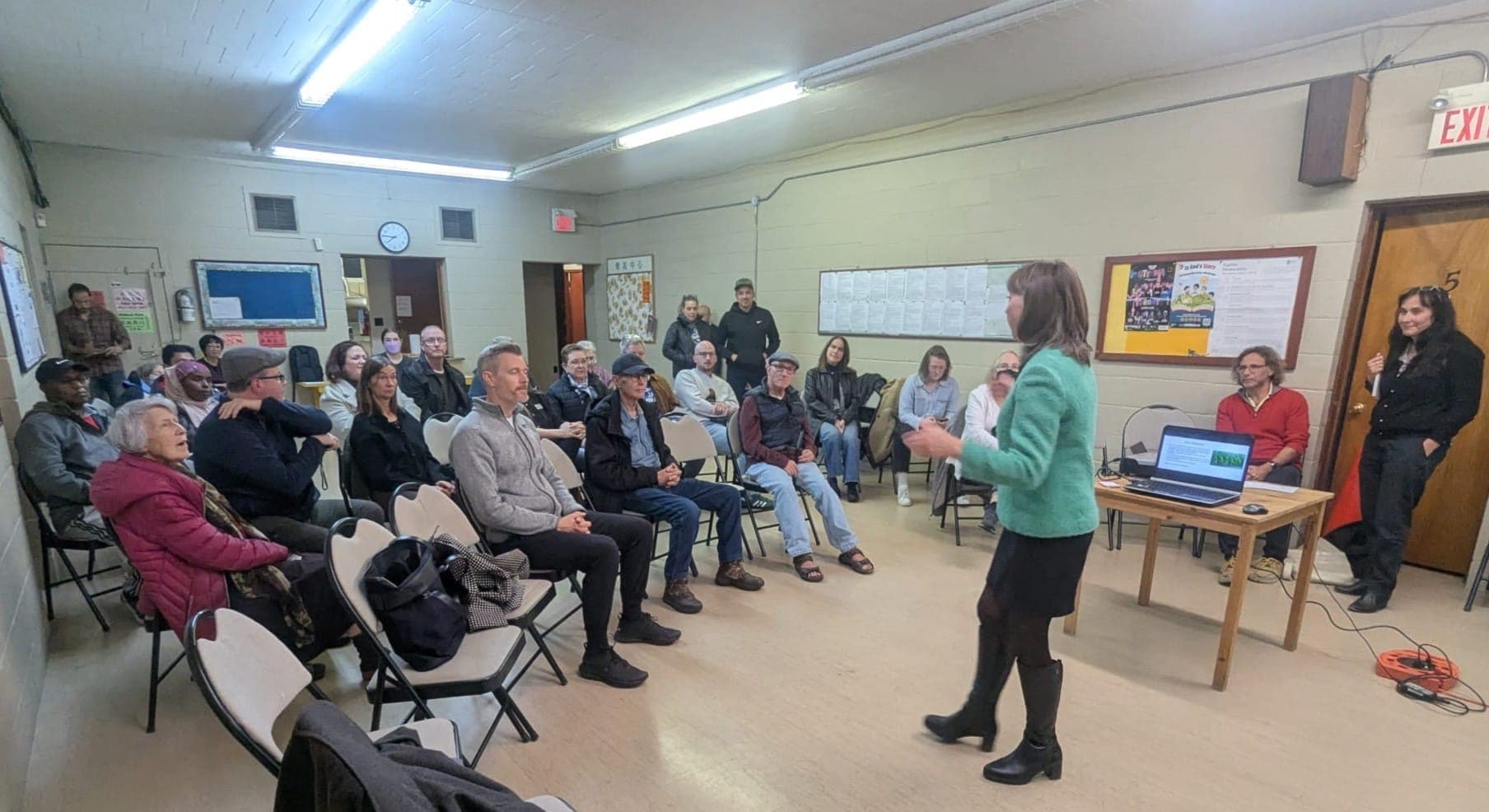 Community meeting with neighbours discussing railway advocacy